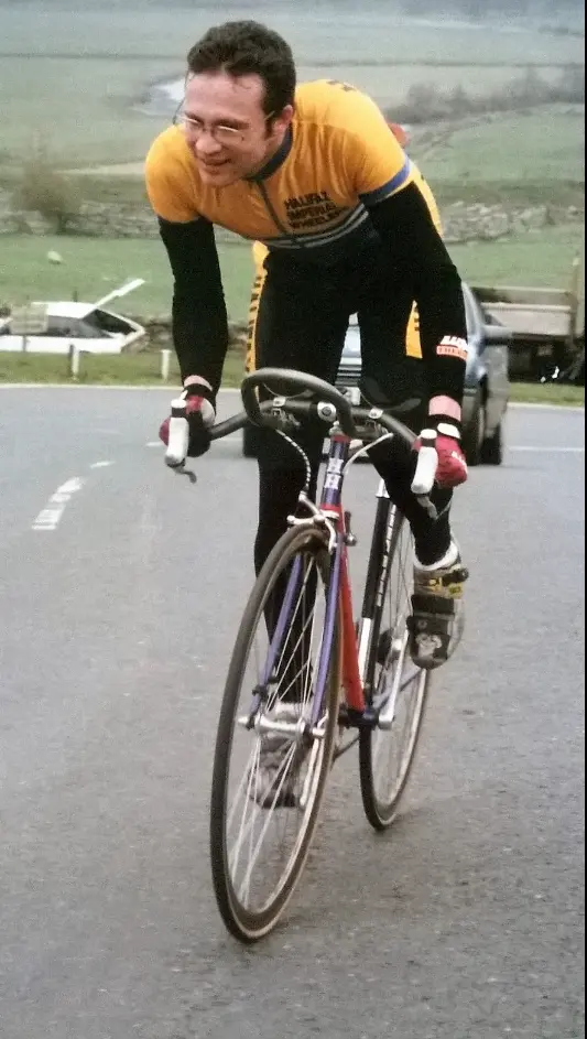 A club rider racing in the club's yellow and blue