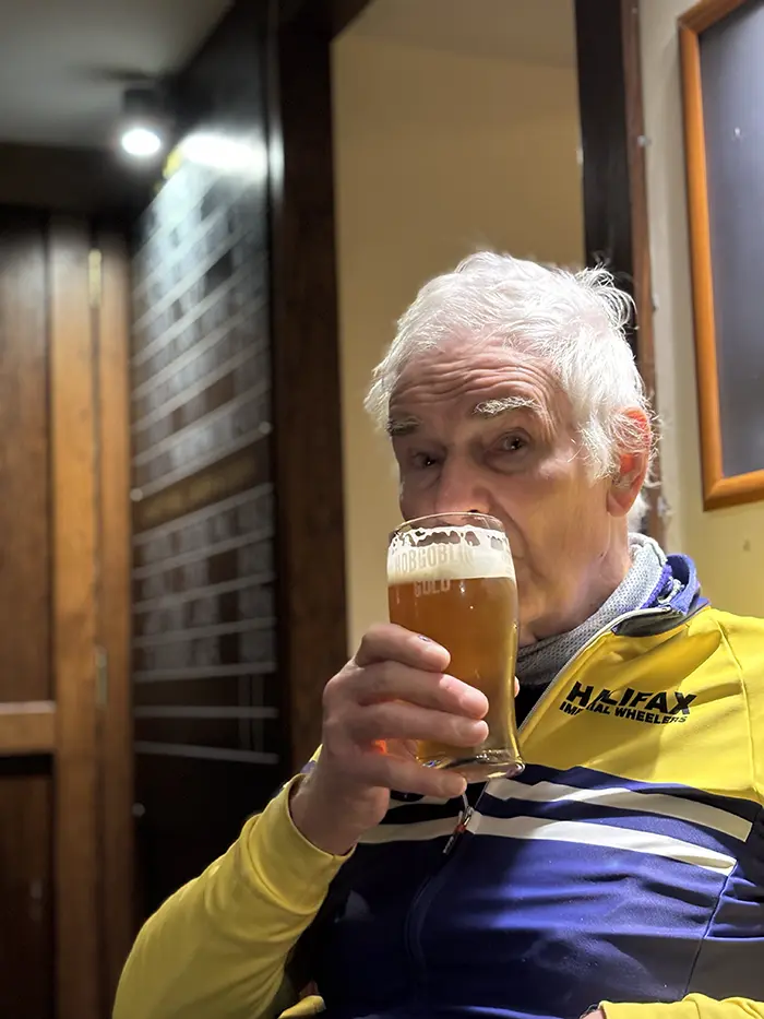 Club members in blue and gold kit at a cafe stop