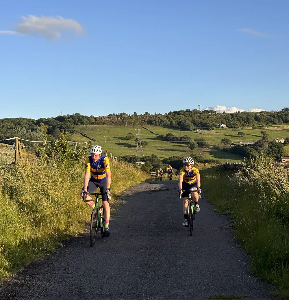 Riders climbing a green Calderdale lane